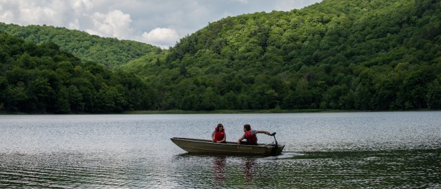 Two people on a rowboat on a lake