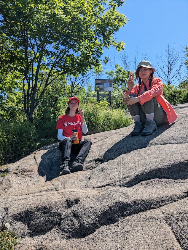 Two interns sit on the summit of Pain De Sucre.
